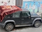 Car damaged after boulder hit in Chamba on Wednesday. (HT Photo)