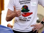 FILE - Jon Torsch wears a t-shirt promoting democratic socialism during a gathering of the Southern Maine Democratic Socialists of America at City Hall in Portland, Maine, July 16, 2018.