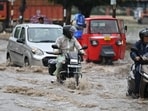 Vehicles wade through a waterlogged stretch following heavy rain in Gurugram on Thursday. (Parveen Kumar/ HT Photo)