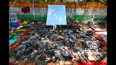 A young, good-natured man collected the hurriedly abandoned footwear from the July 20 protest march the next morning (Vipin Kumar/Hindustan Times) A young, good-natured man collected the hurriedly abandoned footwear from the July 20 protest march the next morning (Vipin Kumar/Hindustan Times)