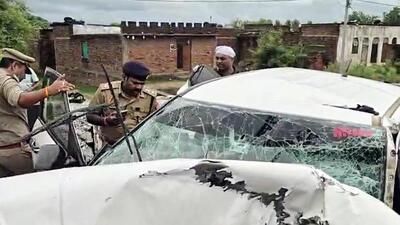 Police personnel inspect the mangled remains of the vehicle at the site of the accident Jhansi on Thursday. (ANI VIDEO GRAB) Police personnel inspect the mangled remains of the vehicle at the site of the accident Jhansi on Thursday. (ANI VIDEO GRAB)