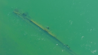 A drone view shows a sunken German warship from World War II, exposed due to low Danube River levels caused by drought and extreme heat.