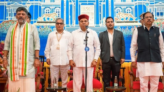 Karnataka Governor Thaawarchand Gehlot with state Chief Minister DK Shivakumar and Deputy Chief Minister G Parameshwara during the Karnataka Cabinet expansion ceremony at Raj Bhavan (@DKShivakumar X)