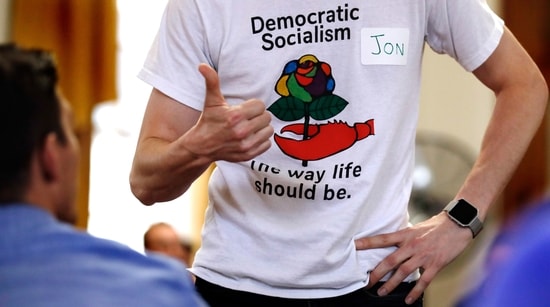 FILE - Jon Torsch wears a t-shirt promoting democratic socialism during a gathering of the Southern Maine Democratic Socialists of America at City Hall in Portland, Maine, July 16, 2018.