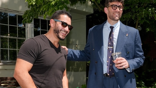 Abdul El-Sayed, candidate in the Democratic primary for US Senate in Michigan, talks poolside with streamer Hasan Piker at a party for content creators supporting his campaign, Monday, Aug. 3, 2026, in Detroit. 