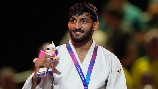 India's Harsh Singh poses with his gold medal in the men's 60kg judo at the Commonwealth Games in Glasgow. (AP Photo)