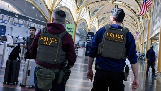 Immigration and Customs Enforcement agents patrol Ronald Reagan Washington National Airport.