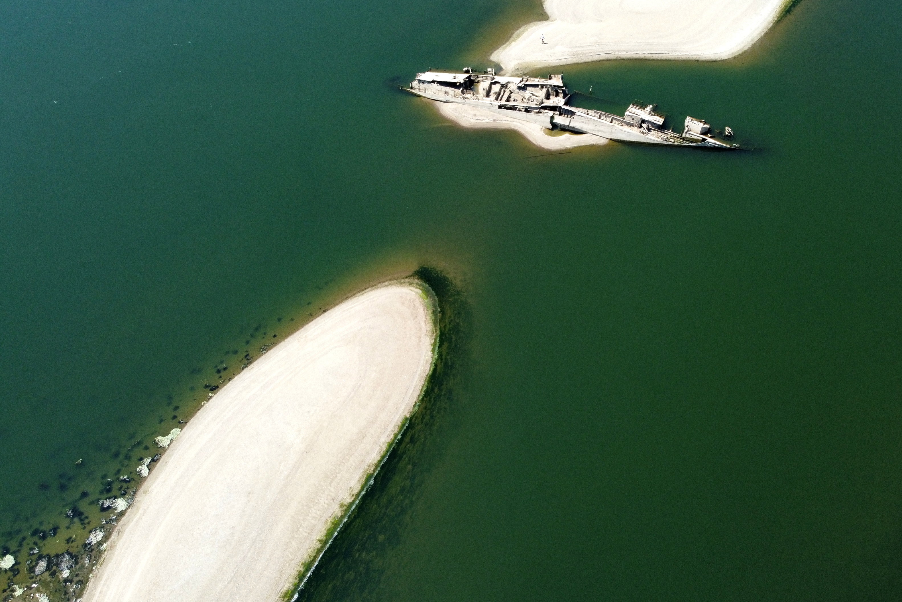 The wreckage of a WWII German warship emerges, due to the drought, in front of Djerdap II, a large dam on the Danube River, between Romania and Serbia, near Prahovo, Serbia. (AP Photo/Darko Vojinovic) The wreckage of a WWII German warship emerges, due to the drought, in front of Djerdap II, a large dam on the Danube River, between Romania and Serbia, near Prahovo, Serbia. (AP Photo/Darko Vojinovic)