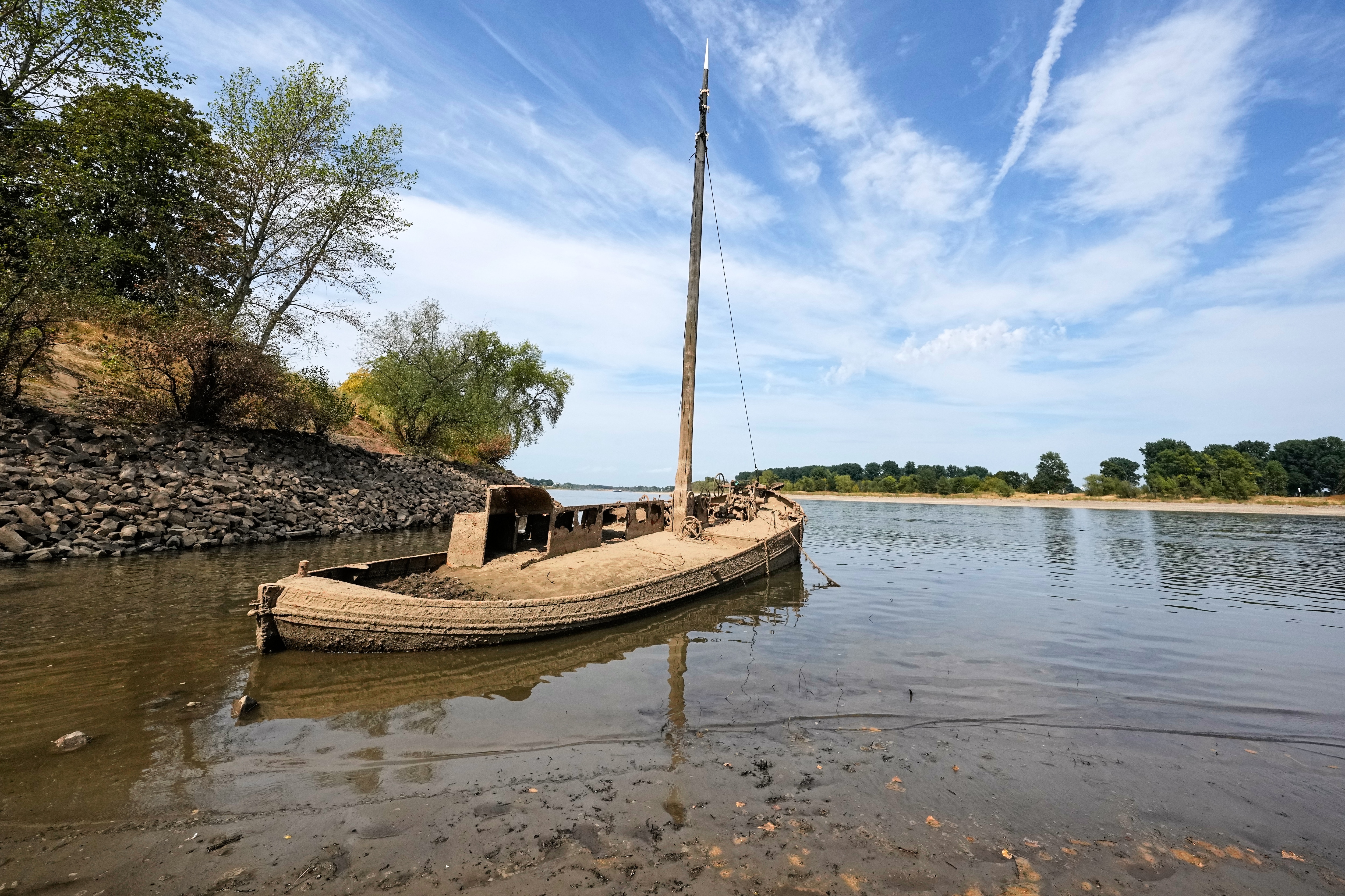 An old eel barge shipwreck is exposed in the Rhine River due to low water levels, a heat wave and prolonged drought near Neuss, Germany, (AP Photo/Martin Meissner) An old eel barge shipwreck is exposed in the Rhine River due to low water levels, a heat wave and prolonged drought near Neuss, Germany, (AP Photo/Martin Meissner)