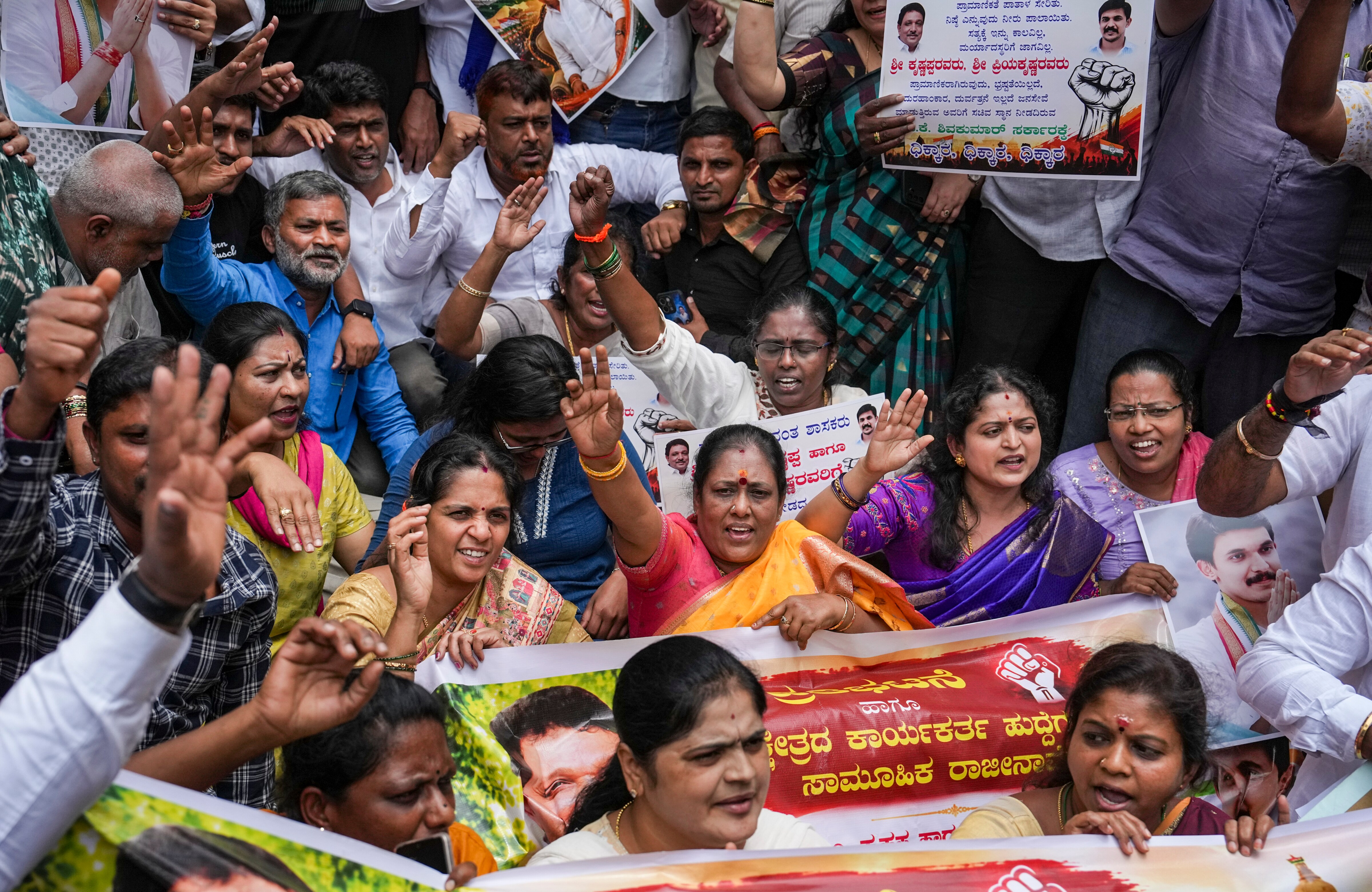Supporters of senior Congress MLA M Krishnappa and his son Priya Krishna raise slogans during a protest demanding their induction into the Karnataka Cabinet, outside the KPCC office, in Bengaluru. (PTI) Supporters of senior Congress MLA M Krishnappa and his son Priya Krishna raise slogans during a protest demanding their induction into the Karnataka Cabinet, outside the KPCC office, in Bengaluru. (PTI)