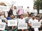 A group of people hold placards during a protest demanding the implementation of an economically based reservation policy at Hazratganj Crossing in Lucknow. A group of people hold placards during a protest demanding the implementation of an economically based reservation policy at Hazratganj Crossing in Lucknow.