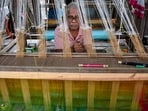 An artisan weaves on a traditional handloom at a rural workshop, a day ahead of National Handloom Day, in Nadia district, West Bengal, Thursday, Aug. 6, 2026.(PTI)