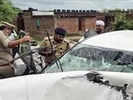 Police personnel inspect the mangled remains of the vehicle at the site of the accident Jhansi on Thursday. (ANI VIDEO GRAB)