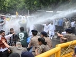 Police used water cannons at AAP leaders and workers to stop them from proceeding towards the Lok Bhavan in Chandigarh on Thursday. (Keshav Singh/HT)