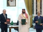 Turkish President Tayyip Erdogan, Saudi Crown Prince Mohammed bin Salman and Pakistan's Prime Minister Shehbaz Sharif pose after signing a joint defense agreement in Mecca, Saudi Arabia. 