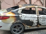 The charred vehicle after it was set on fire by unidentified miscreants in Bhai Himmat Singh Nagar, Dugri, Ludhiana on Friday. (HT Photo)