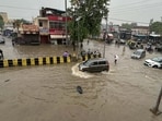 Vehicles navigate through a waterlogged stretch during the heavy monsoon rain at Sec 5 Road in Gurugram on Thursday. (Parveen Kumar/HT)