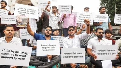 A group of people hold placards during a protest demanding the implementation of an economically based reservation policy at Hazratganj Crossing in Lucknow. (ANI) A group of people hold placards during a protest demanding the implementation of an economically based reservation policy at Hazratganj Crossing in Lucknow. (ANI)