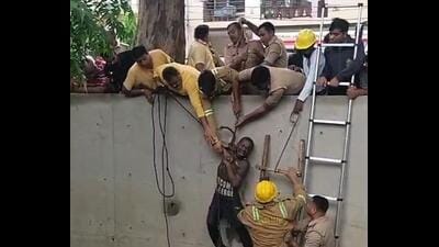 Fire department personnel rescue a 47-year-old man after he reportedly slipped into a drain in the Shastri Nagar locality on Friday. (Sakib Ali/HT PHOTO) Fire department personnel rescue a 47-year-old man after he reportedly slipped into a drain in the Shastri Nagar locality on Friday. (Sakib Ali/HT PHOTO)