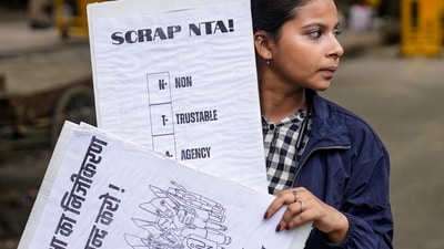 A demonstrator holds placards during a protest against the police crackdown on students and youth over the NEET paper leak issue, at Jantar Mantar. (PTI/File) A demonstrator holds placards during a protest against the police crackdown on students and youth over the NEET paper leak issue, at Jantar Mantar. (PTI/File)