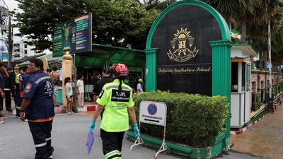 People, including emergency personnel, gather outside Debsirin Nonthaburi School, the site of a shooting incident, in Bang Kruai district in Nonthaburi province on the outskirts of Bangkok (REUTERS)