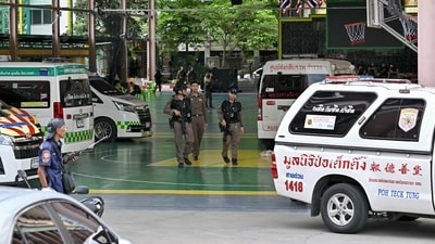 Armed police walk through the school campus in Nonthaburi, Thailand, where a mass shooting took place Friday. Armed police walk through the school campus in Nonthaburi, Thailand, where a mass shooting took place Friday.