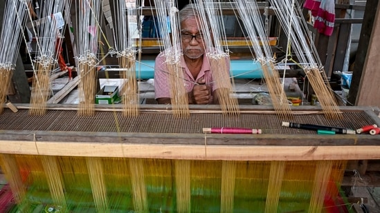 An artisan weaves on a traditional handloom at a rural workshop, a day ahead of National Handloom Day, in Nadia district, West Bengal, Thursday, Aug. 6, 2026.