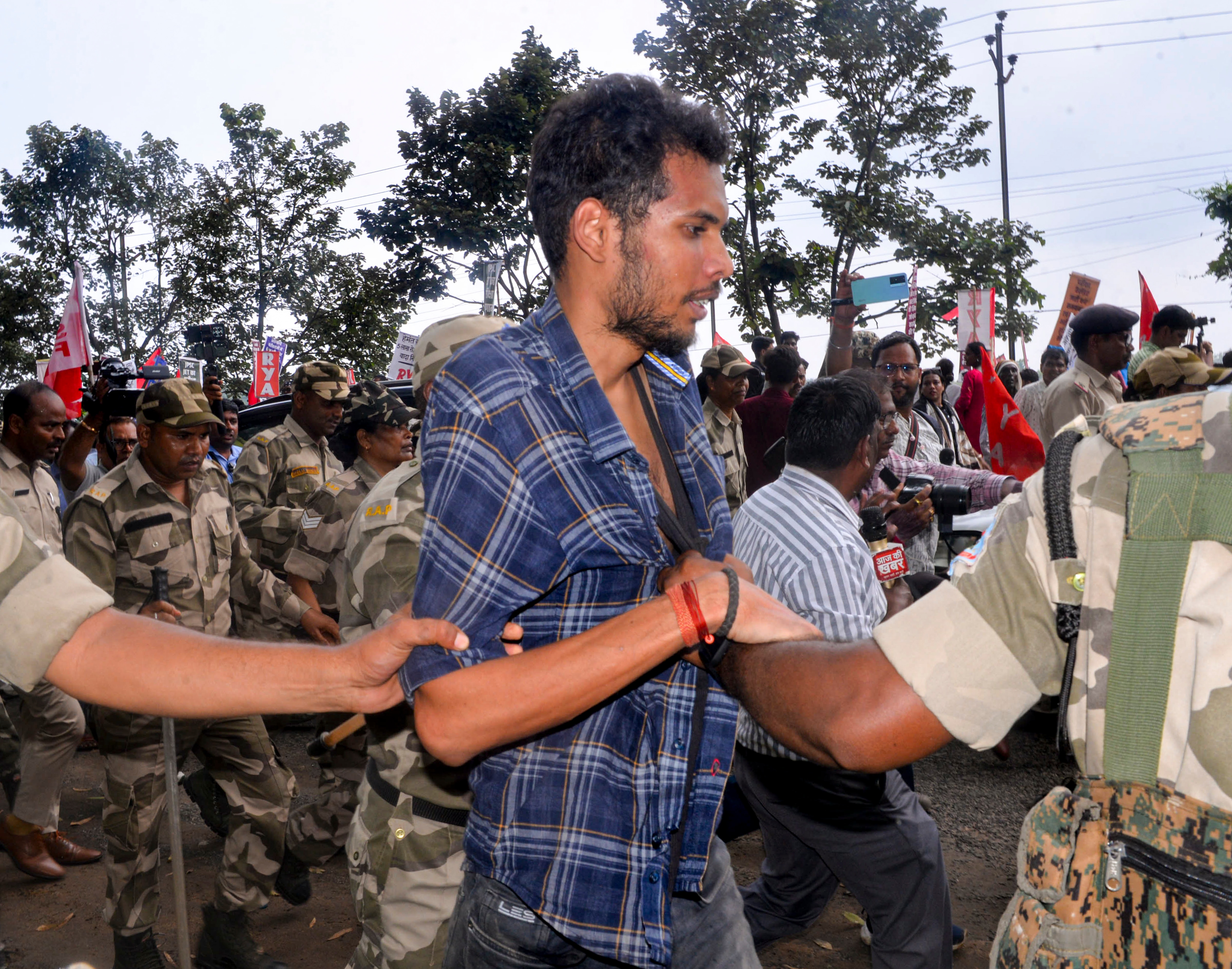 Police personnel detains the man after he threw ink on All India Student's Association (AISA) National President Neha Bora during a protest against the alleged irregularities of examinations conducted by Jharkhand Public Service Commission (JPSC) and Jharkhand Staff Selection Commission (JSSC). (PTI) Police personnel detains the man after he threw ink on All India Student's Association (AISA) National President Neha Bora during a protest against the alleged irregularities of examinations conducted by Jharkhand Public Service Commission (JPSC) and Jharkhand Staff Selection Commission (JSSC). (PTI)