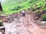 A bike wades through a muddy road following a landslide due to continuous heavy rainfall in Rajouri on Tuesday. (File Photo/ANI)