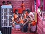 Kanwariyas take rest inside a temporary Kanwar Yatra camp (shivir) after collecting sacred Ganga Jal, as they pause during their onward journey to offer the holy water at Shiva temples.(HT Photos)