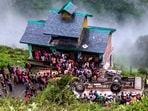 People gathered after a private bus overturned and plunged onto a lower road, in Chamba district, Himachal Pradesh, Saturday, Aug. 8, 2026. At least seven passengers were killed and 11 others were injured.