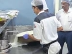 Food Safety and Drug Administration officials at a Bengaluru hotel where expired milk is being destroyed. (ANI videograb)