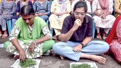 The protesters were seen sitting in a line outside the secretariat, with grass kept on a paper before them (ANI Video Grab)