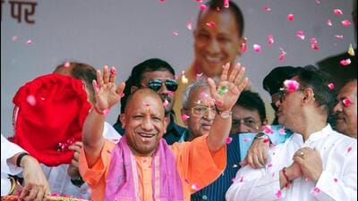 Chief minister Yogi Adityanath showering flowers on Kanwariyas in Meerut on Saturday. (ANI PHOTO) Chief minister Yogi Adityanath showering flowers on Kanwariyas in Meerut on Saturday. (ANI PHOTO)