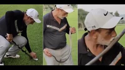 Screenshots from a viral video showing the golfer pinning down the cobra with his 5-iron, clasping it from the head and then kissing it. Screenshots from a viral video showing the golfer pinning down the cobra with his 5-iron, clasping it from the head and then kissing it.