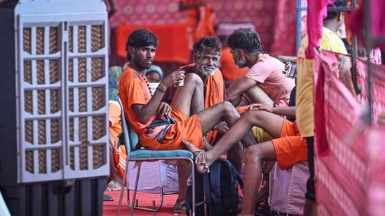 Kanwariyas take rest inside a temporary Kanwar Yatra camp (shivir) after collecting sacred Ganga Jal, as they pause during their onward journey to offer the holy water at Shiva temples.