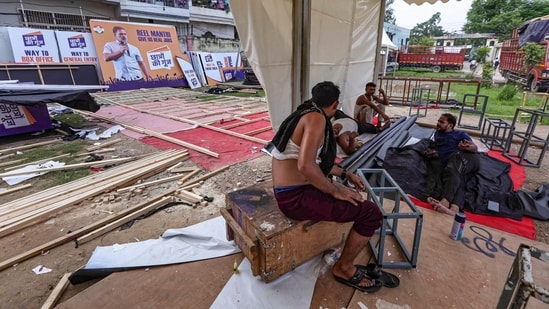 Workers take rest as preparations are underway ahead of LoP in Lok Sabha Rahul Gandhi's 'Chhatron Ki Goonj' programme.