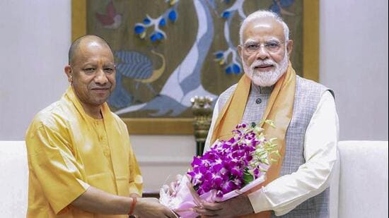 Uttar Pradesh chief minister Yogi Adityanath with Prime Minister Narendra Modi in New Delhi on Saturday. (PTI)