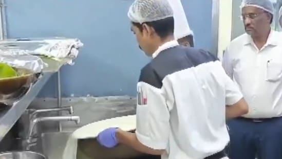 Food Safety and Drug Administration officials at a Bengaluru hotel where expired milk is being destroyed.