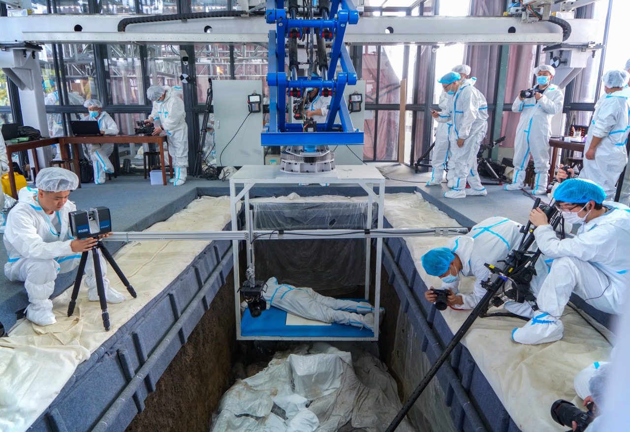 A team works around one of the ancient sacrificial pits. A team works around one of the ancient sacrificial pits.