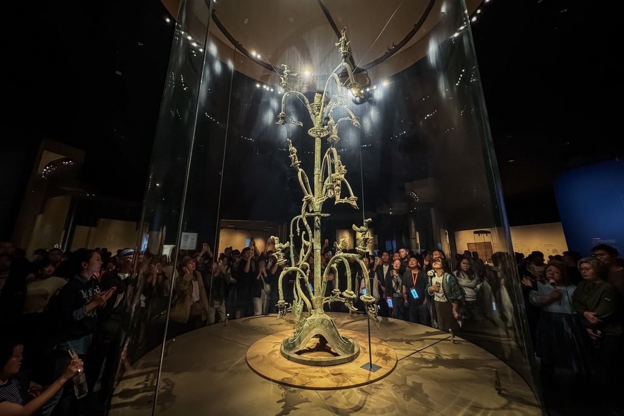 Visitors to the Sanxingdui museum view an intricate bronze 'sacred tree.' Visitors to the Sanxingdui museum view an intricate bronze 'sacred tree.'