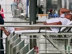 A staff member present with an injured passenger on a stretcher after several passengers, including crew members, got injured as Air India flight (AI2379) from Phuket to Delhi experienced a brief in-flight turbulence.