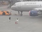 A viral video showed two women dashing across an airport tarmac after reportedly missing their flight in Russia.