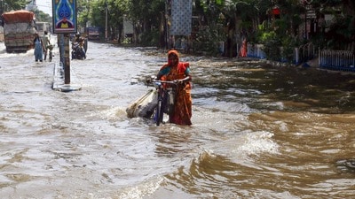 Kolkata: A woman wades through the waterlogged street of south Kolkata due to heavy rainfall, in Kolkata on Wednesday. (ANI Photo) Kolkata: A woman wades through the waterlogged street of south Kolkata due to heavy rainfall, in Kolkata on Wednesday. (ANI Photo)