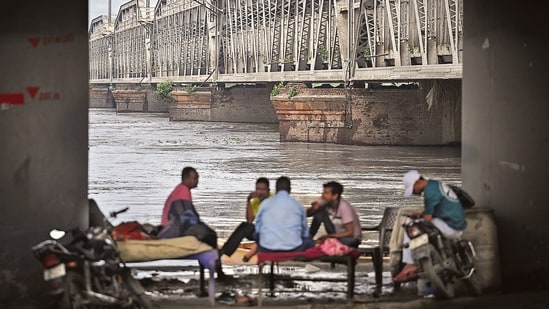 At the Yamuna’s monitoring point at Delhi’s Old Railway Bridge, the water level reached 204.06 metres at 8pm, just 44cm below the warning mark of 204.50 metres. Meanwhile, the Hindon crossed its warning level of 195.76 metres at 8pm at the river’s Noida base station. (HT Photo/Sanchit Khanna)