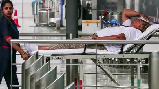 A staff member present with an injured passenger on a stretcher after several passengers, including crew members, got injured as Air India flight (AI2379) from Phuket to Delhi experienced a brief in-flight turbulence.