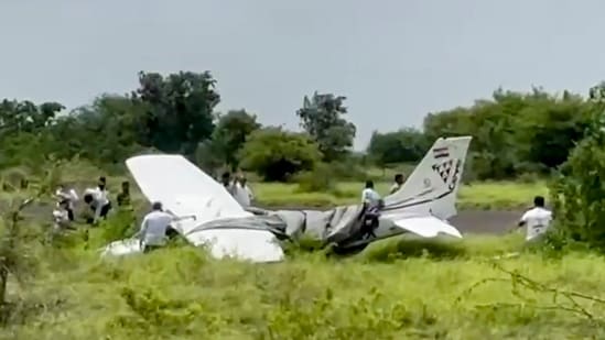 Baramati: Local residents and officials gather around the wreckage of a trainer aircraft that crash-landed near the airstrip at Baramati Airport, in Pune district, Maharashtra, Sunday, Aug. 9, 2026. 