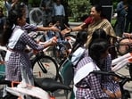 Delhi Chief Minister Rekha Gupta greets girl students as they leave with their bicycles after she flags off the distribution of free bicycles to students enrolled in Delhi government schools under the Vidya Vahini Yojana at the Delhi Legislative Assembly in New Delhi, India on Monday.
