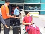 Medical pesonnel present with an injured crew member in a wheelchair as Air India flight (AI2379) from Phuket to Delhi experienced brief in-flight turbulence.(ANI Video Grab)