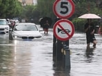 People wade through a flooded street after Typhoon Dolphin brought heavy rain to Shanghai, China.